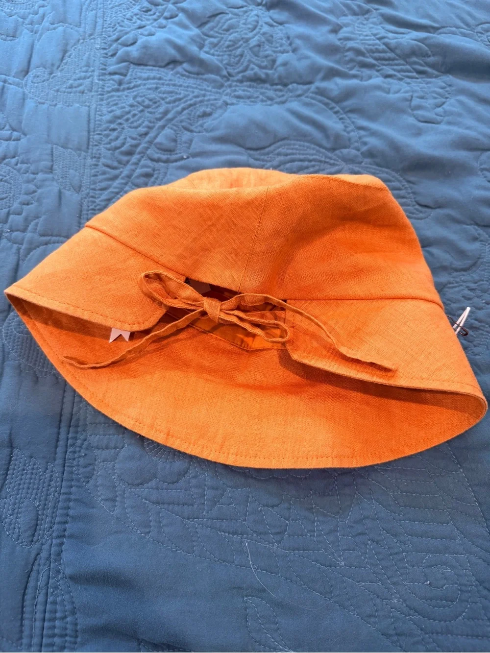 By The Sea Gold/Orange Kids Sun Bonnet/Hat with ties in back to adjust fit.